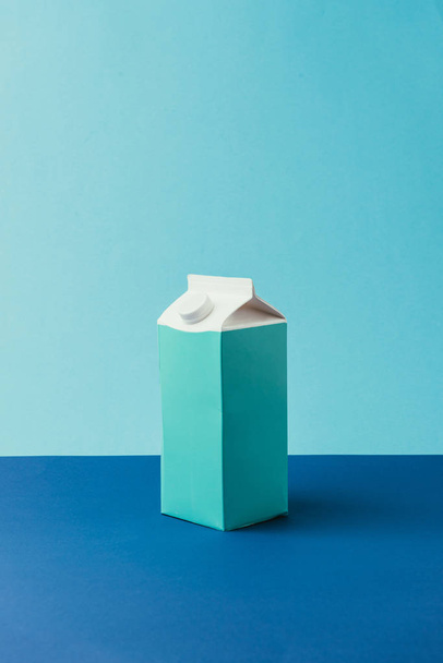close up view of empty cardboard package on blue background, recycle concept - 写真・画像