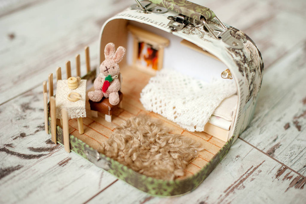 Dollhouse with a rabbit on a chair - Фото, изображение