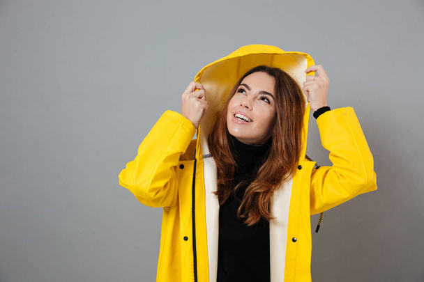 Portrait of a smiling girl dressed in raincoat - Фото, изображение