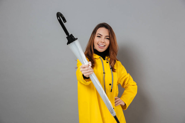 Portrait of a cheerful girl dressed in raincoat - Photo, Image