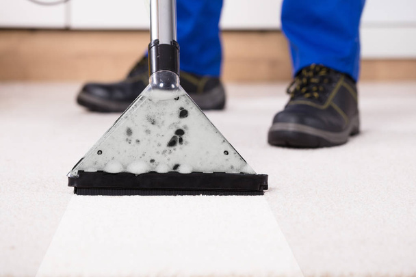 Close-up Of A Person Using Vacuum Cleaner For Cleaning Carpet At Home - Photo, Image