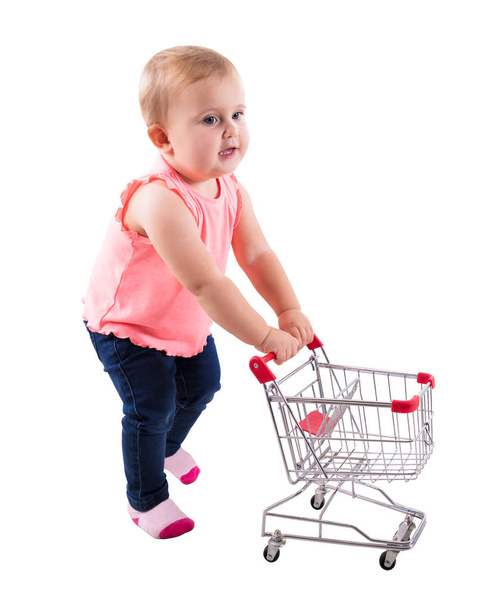 Baby Girl Holding Small Shopping Cart On White Background - Foto, afbeelding