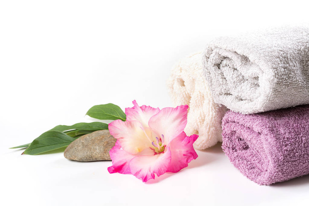Spa setting of towel, pink flower isolated on white. Copy space. Square image. - Foto, immagini