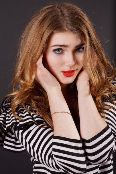 Beautiful young girl in a striped blouse - Фото, зображення