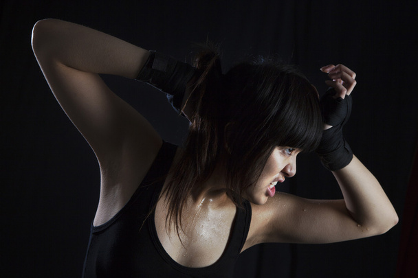 Perspiring Young Asian Woman working out - 写真・画像