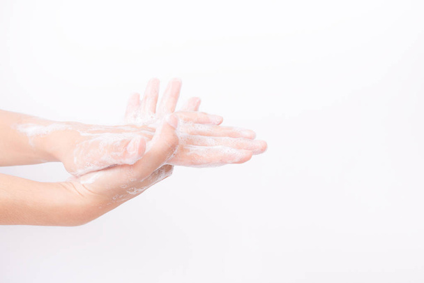 Asian girl hands are washing with soap bubbles on white background - Фото, изображение