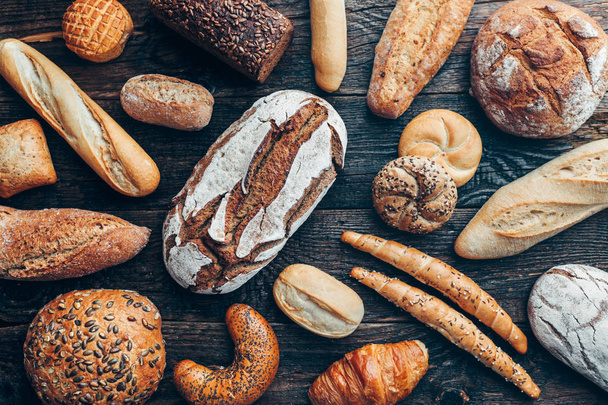Delicious fresh bread on wooden background - Foto, immagini