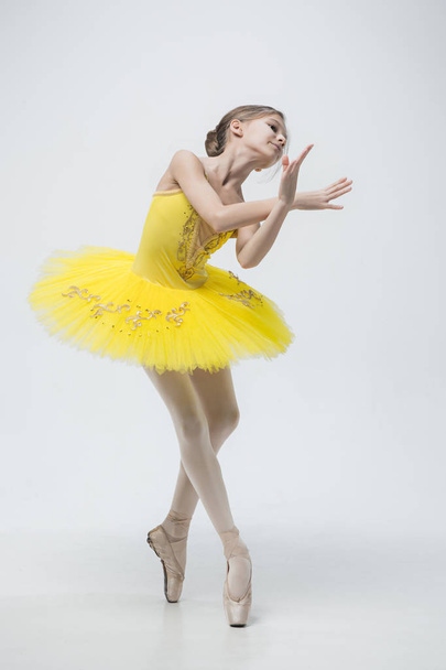 Young classical dancer on white background. - 写真・画像