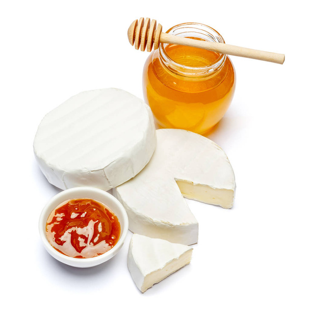 Round brie or camambert cheese, honey and jam on a white background - Photo, image