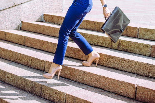 legs of businesswoman walking  down the stairs  - Фото, изображение