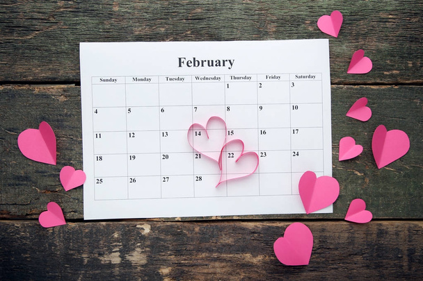 Pink hearts with february calendar on wooden table - Photo, Image