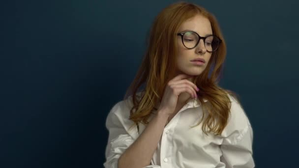 Portrait of student girl on blue background - Felvétel, videó