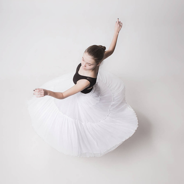 The top view of the teen ballerina on white background - Φωτογραφία, εικόνα
