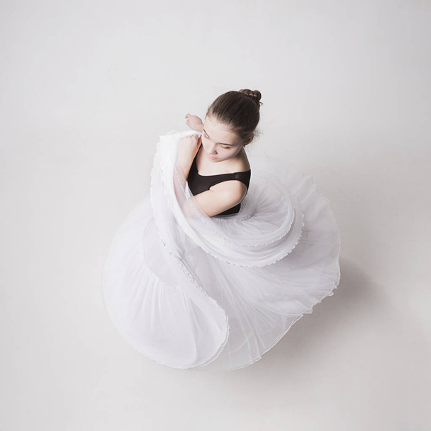 The top view of the teen ballerina on white background - Foto, afbeelding