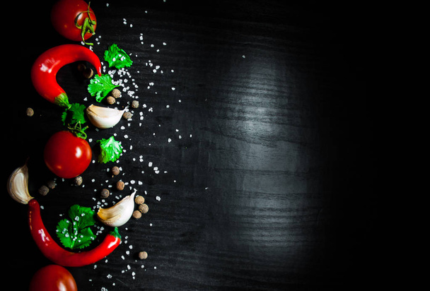 Garlic, red chili peppers, tomato on dark wooden background with copy space. top view - Foto, immagini