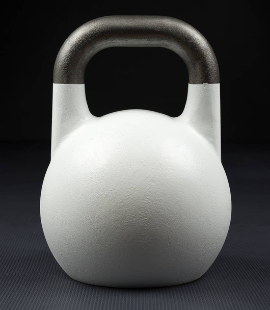 Witte Gewichtheffen kettlebell in een sportschool. Oefening / fitness / Nieuwjaars resolutie concept. - Foto, afbeelding