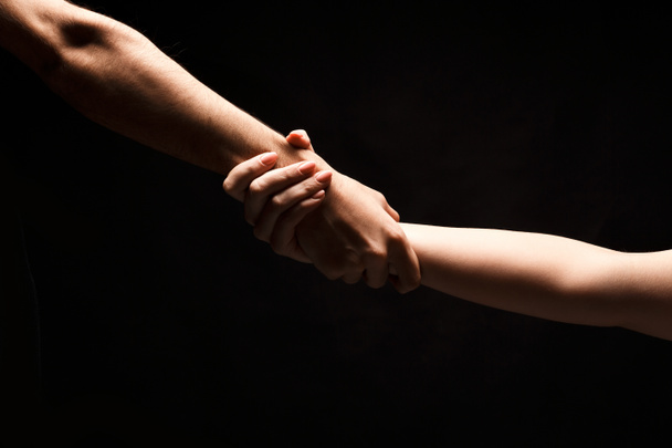 Hands of man and woman in love, isolated on black - Photo, Image