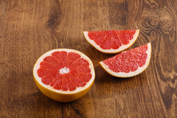 pieces of grapefruit on the wooden table - Photo, Image