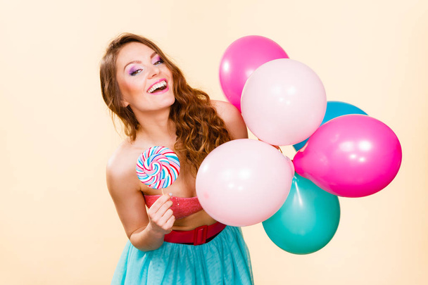 Woman holds lollipop candy and balloons - Foto, Imagem