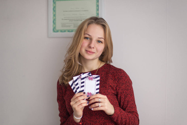 Beautifully designed winning tickets in the hands of a young gir - Zdjęcie, obraz