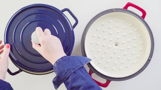 Brand new enameled cast iron covered dutch oven on a white background. - Foto, Bild