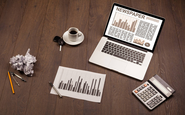 Business laptop with stock market report on wooden desk - Photo, Image