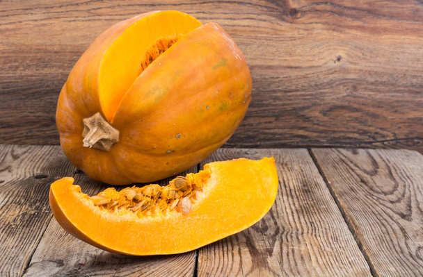 Cut pumpkin on wooden table - Photo, Image