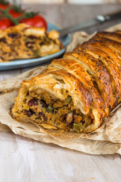 Pork roll - spicy sausage meat with chillies and beans in puff pastry - Foto, Bild