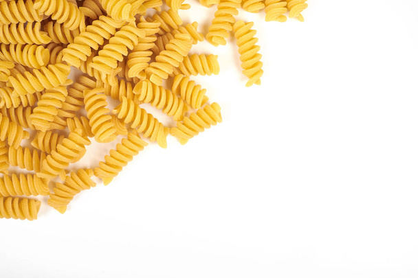 uncooked fusilli pasta noodles isolated on white background - Foto, Bild