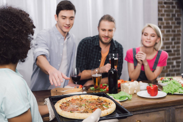 african american girl bringing homemade pizza to friends - Foto, Bild