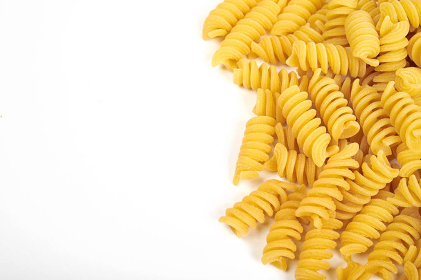 uncooked fusilli pasta noodles isolated on white background - Foto, Bild
