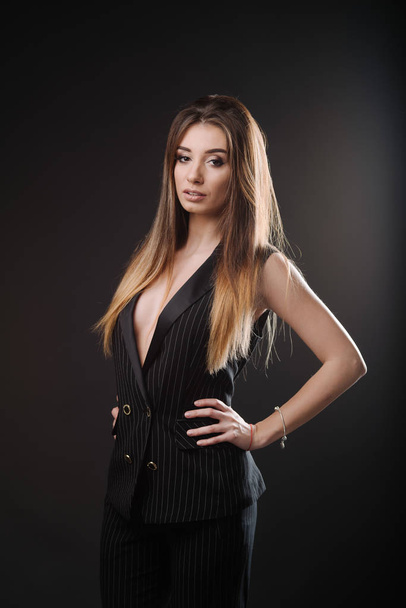 Beautiful young woman in  dress clothes posing in studio - Photo, Image