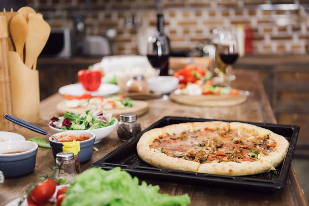 homemade delicious pizza on table in kitchen - Photo, Image