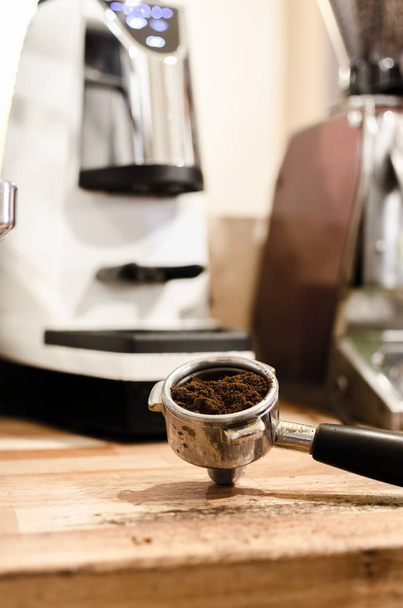 Delicious fresh morning espresso coffee in portafilter, machine in background - Фото, зображення