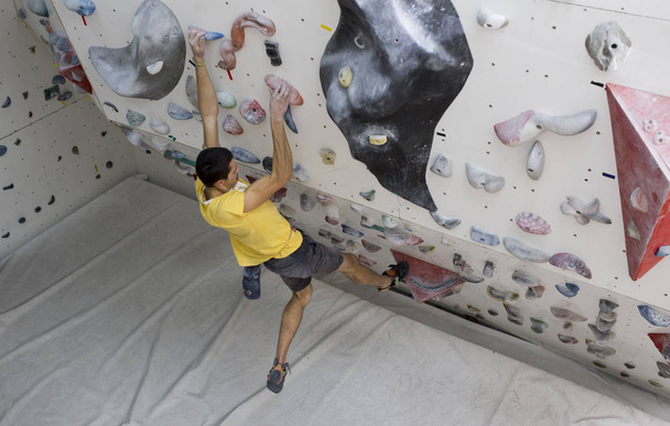 Indoor rock climbing man - 写真・画像