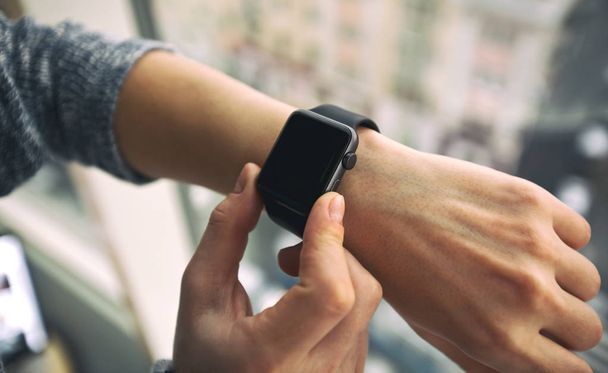 The modern smart watch on the woman's hand - 写真・画像