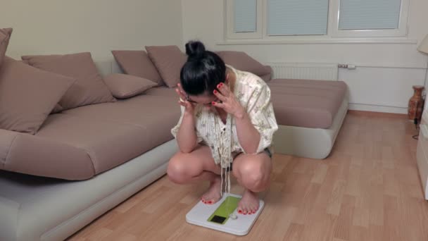 Stressful woman on electronic scale - Footage, Video