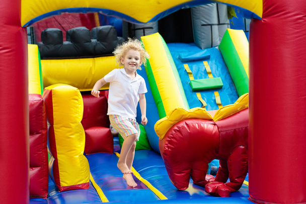 Child jumping on playground trampoline. Kids jump. - Fotografie, Obrázek