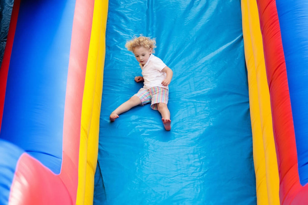 Child jumping on playground trampoline. Kids jump. - Photo, Image
