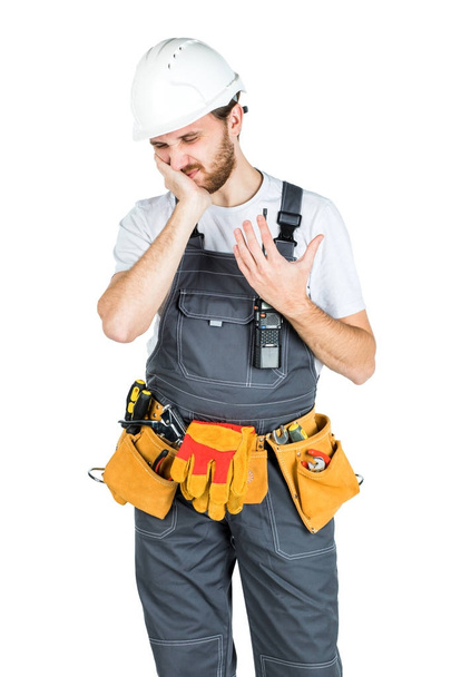 Un constructor o empleado en un casco protector sostiene una manija cerca
 - Foto, imagen