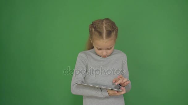 Ragazza giovane e concepita utilizzando la tecnologia touchscreen tablet e la lettura
. - Filmati, video