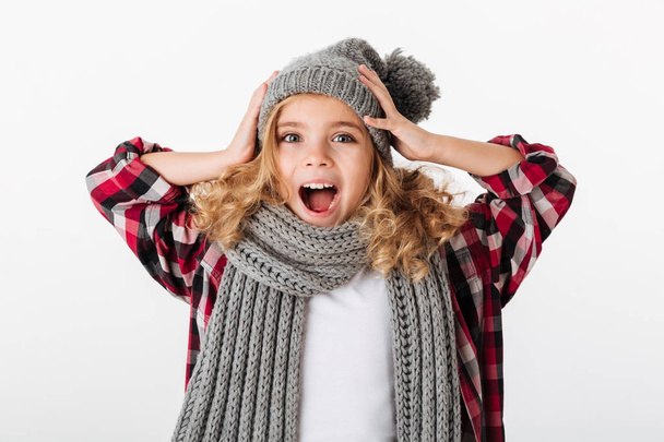 Portrait of an excited little girl dressed in winter hat - Foto, Imagen