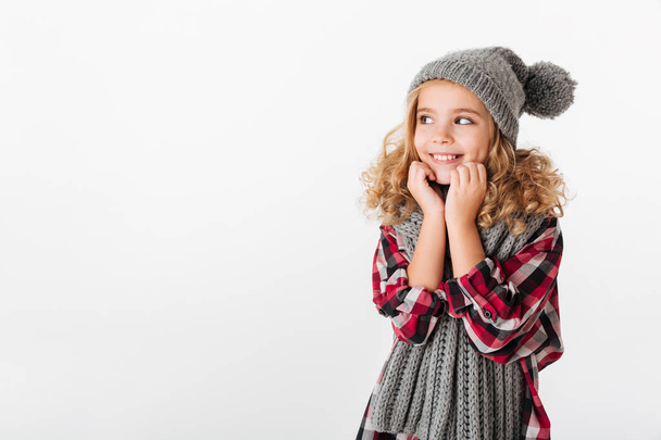 Portrait of a lovely little girl dressed in winter hat - Фото, изображение
