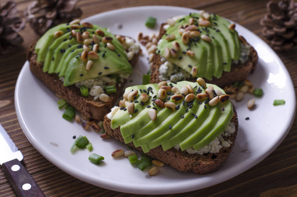 Bruschetta with blue avocado cheese and pine nuts   - Photo, Image