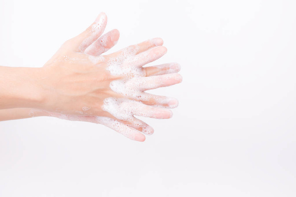 Asian girl hands are washing with soap bubbles on white background - Foto, Bild