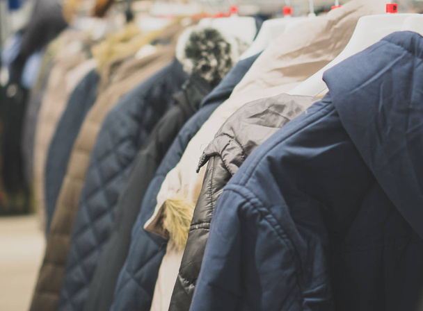 Collection of winter jackets in clothing store. - Foto, afbeelding