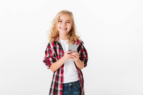 Retrato de una niña sonriente sosteniendo el teléfono móvil
 - Foto, imagen