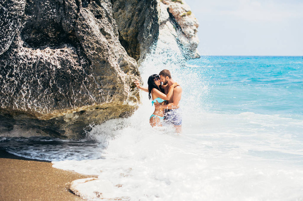 Couple in love hugs on the beach. Couple at sea. Guy and girl resting on the sea. Man and woman resting at the resort. A couple in love travels. Honeymoon. Honeymoon trip - Fotó, kép