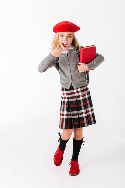 Full length portrait of a cheerful little schoolgirl - Фото, зображення
