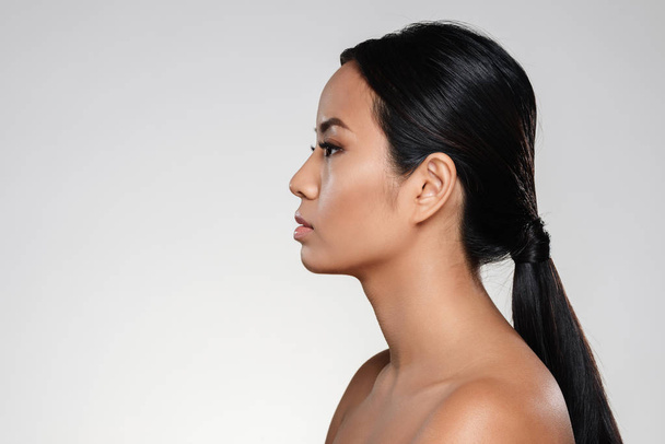 Side view portrait of a young half naked asian woman - Foto, immagini
